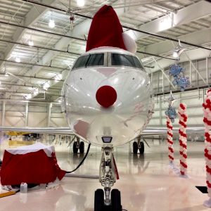 a plane wears a Santa hat and a Rudolph nose