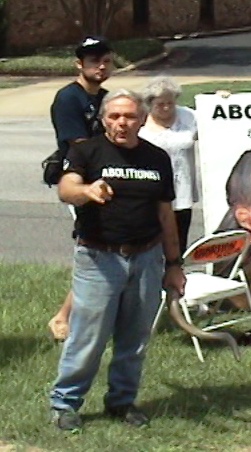 Holding his ram's horn, Chip Nix explains why you are going to hell for not believing as he does