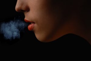 woman blowing smoke