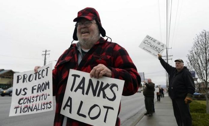 protestors on the side of the road in Spokana