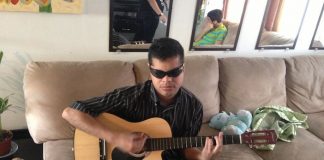 Blind Musician Edgar Cabachuela Of Many Talents Playing One of Many Instruments and Singer