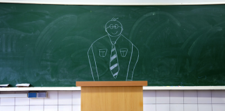 Image of a teacher drawn on a blackboard behind the podium