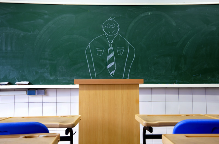 Image of a teacher drawn on a blackboard behind the podium